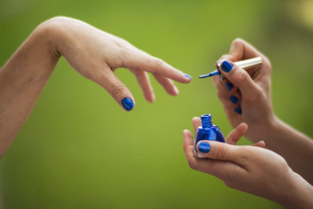 A manicure in progress with fresh nail polish